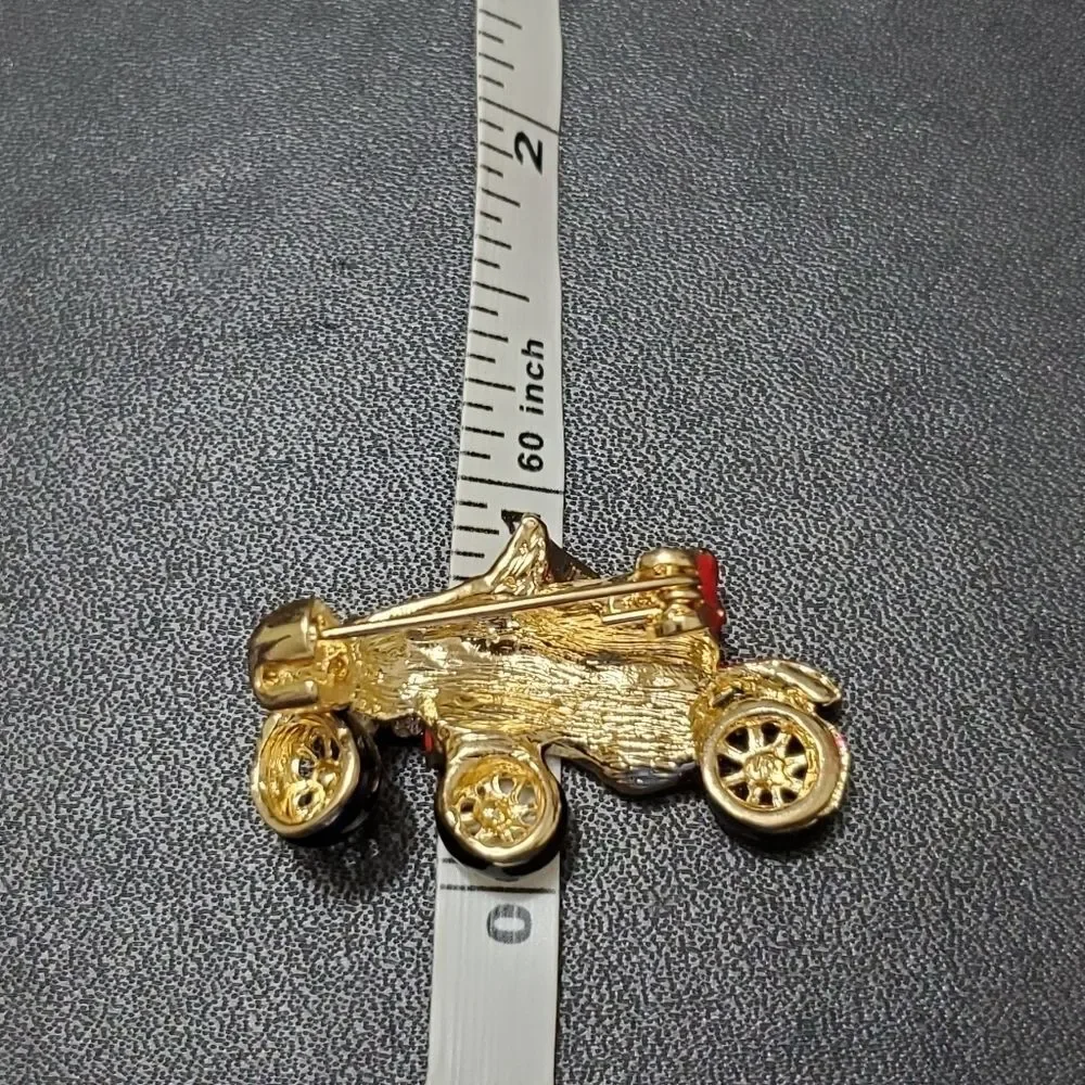 Gold tone red enamel antique car brooch